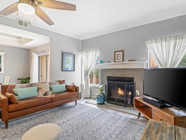 505 Oppenheimer Dr Unit 1304, Los Alamos, NM 87544 - living area with ceiling fan, visible vents, wood finished floors, a tile fireplace, and ornamental molding