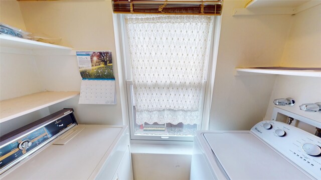 clothes washing area with laundry area and washer / clothes dryer