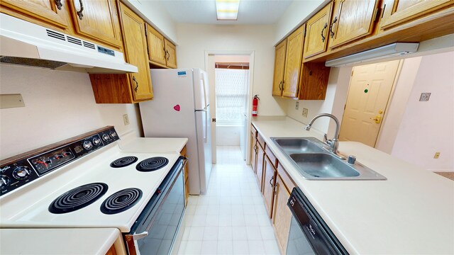 kitchen with a sink, under cabinet range hood, white appliances, and light countertops