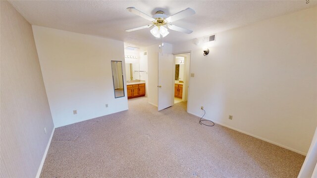 unfurnished room with light carpet, a ceiling fan, and visible vents