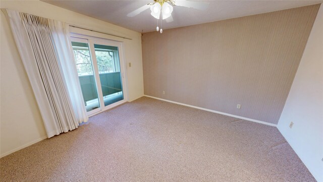 empty room featuring baseboards, a ceiling fan, and light colored carpet