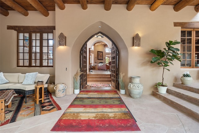 35 Sage Cir, Santa Fe, NM 87506 - hallway featuring arched walkways, tile patterned flooring, and beamed ceiling
