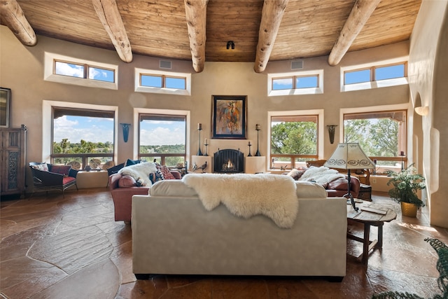 35 Sage Cir, Santa Fe, NM 87506 - living room featuring wooden ceiling, beamed ceiling, and stone tile flooring