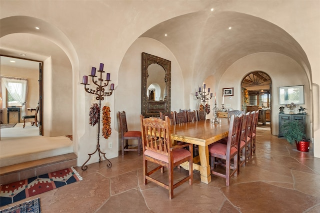 35 Sage Cir, Santa Fe, NM 87506 - dining area with arched walkways and stone tile flooring