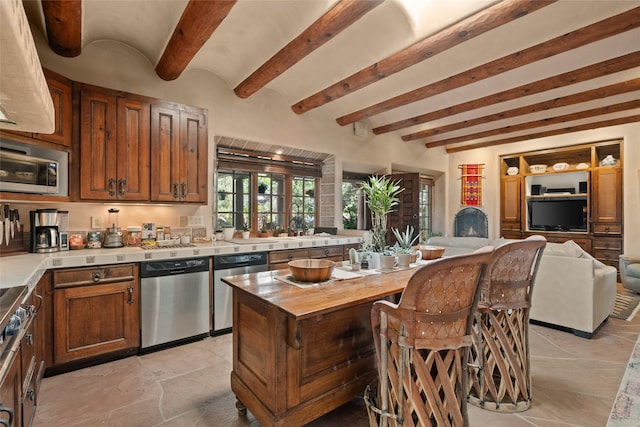35 Sage Cir, Santa Fe, NM 87506 - kitchen with appliances with stainless steel finishes, beam ceiling, a sink, open floor plan, and butcher block countertops