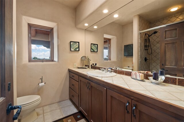 35 Sage Cir, Santa Fe, NM 87506 - full bathroom featuring vanity, tile patterned floors, toilet, recessed lighting, and tiled shower