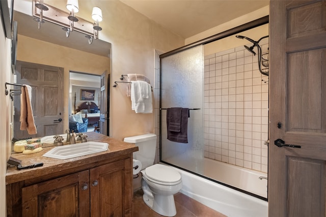 35 Sage Cir, Santa Fe, NM 87506 - ensuite bathroom featuring vanity, tile patterned flooring, toilet, ensuite bathroom, and combined bath / shower with glass door