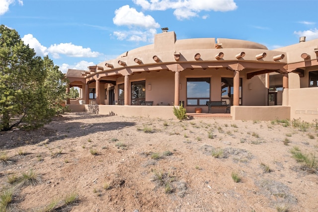 35 Sage Cir, Santa Fe, NM 87506 - back of property featuring a chimney