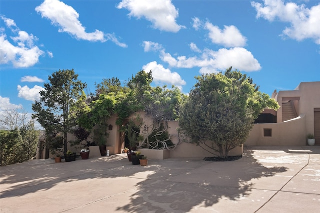 35 Sage Cir, Santa Fe, NM 87506 - exterior space with stucco siding and a patio area