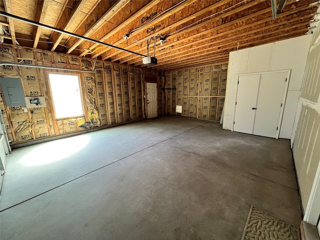 below grade area featuring electric panel and a garage