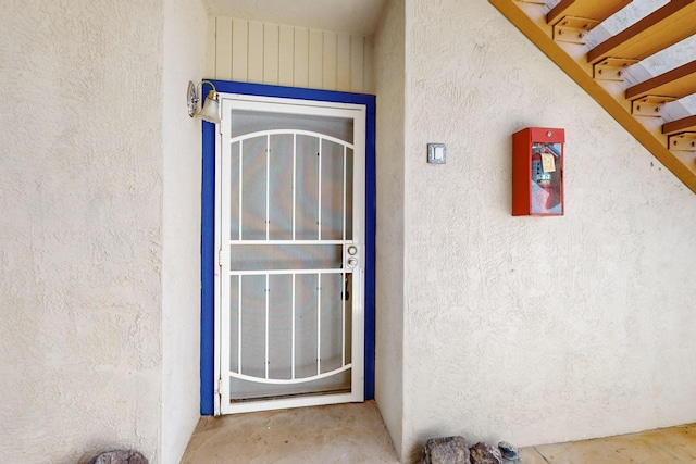 view of exterior entry with stucco siding