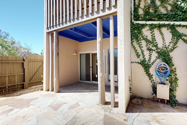 view of patio / terrace with fence, a gate, and a balcony