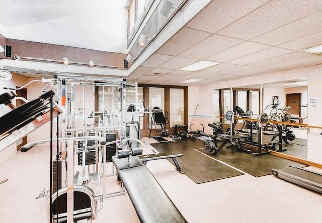 gym with a paneled ceiling
