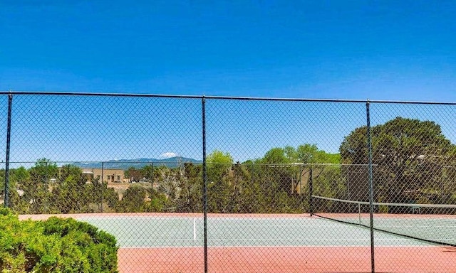 view of sport court featuring fence