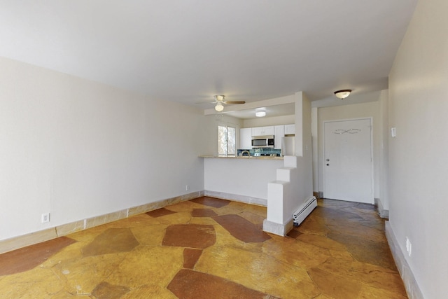 unfurnished living room featuring stone finish floor, a baseboard radiator, baseboards, and a ceiling fan
