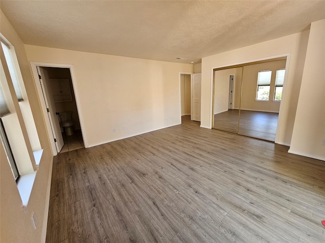 unfurnished room featuring baseboards and wood finished floors