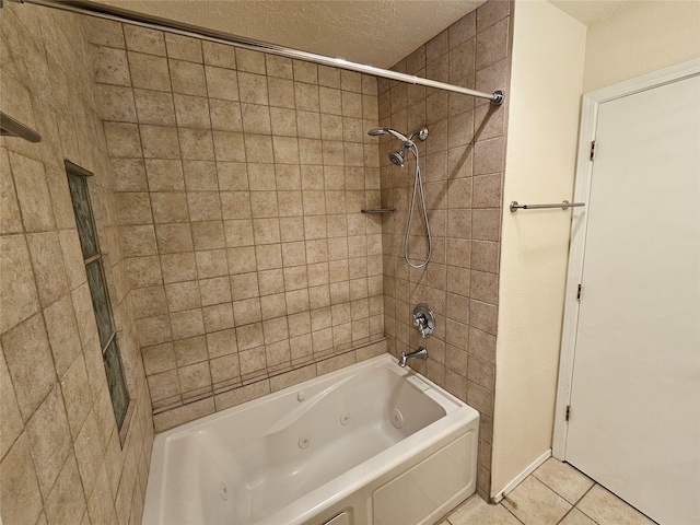 bathroom with a textured ceiling, tile patterned floors, and a combined bath / shower with jetted tub