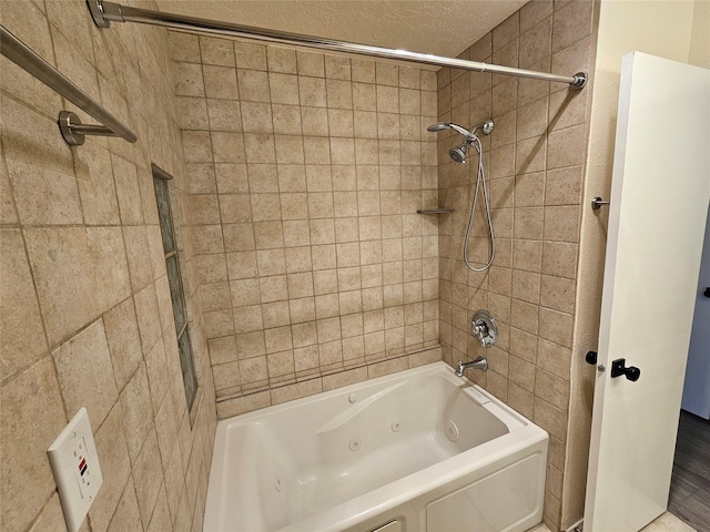 full bathroom with a textured ceiling and a combined bath / shower with jetted tub
