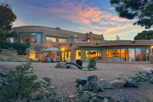 view of back of house at dusk