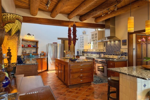 kitchen featuring wood ceiling, beamed ceiling, stainless steel appliances, and wall chimney exhaust hood