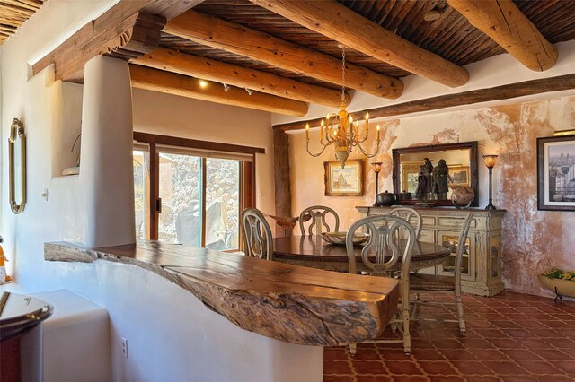 dining area featuring beam ceiling, a notable chandelier, and wood ceiling