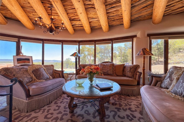 carpeted living area featuring wood ceiling, a mountain view, a chandelier, and beamed ceiling