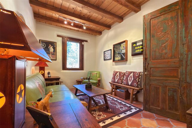 living area with wood ceiling and beam ceiling