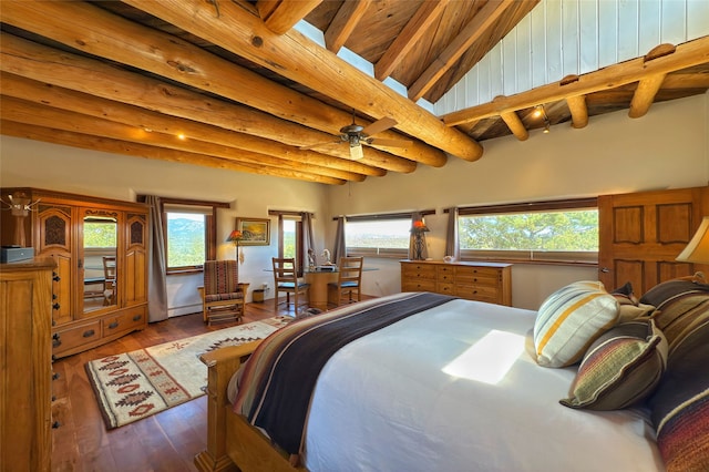 bedroom featuring multiple windows, wood-type flooring, and beam ceiling