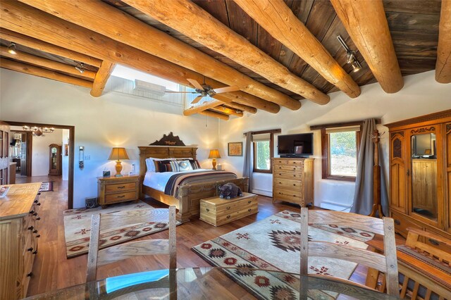 bedroom with track lighting, wood ceiling, hardwood / wood-style floors, and beamed ceiling