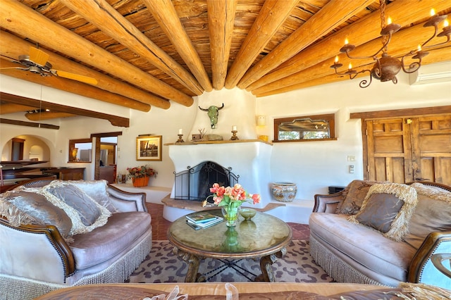 living area with arched walkways, beam ceiling, and a fireplace