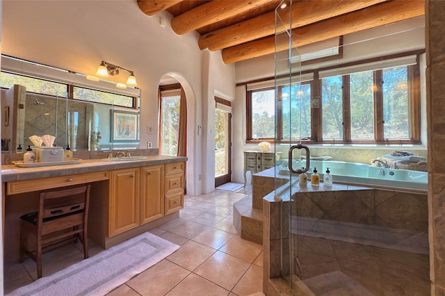 bathroom featuring tile patterned floors, a wealth of natural light, beam ceiling, and vanity