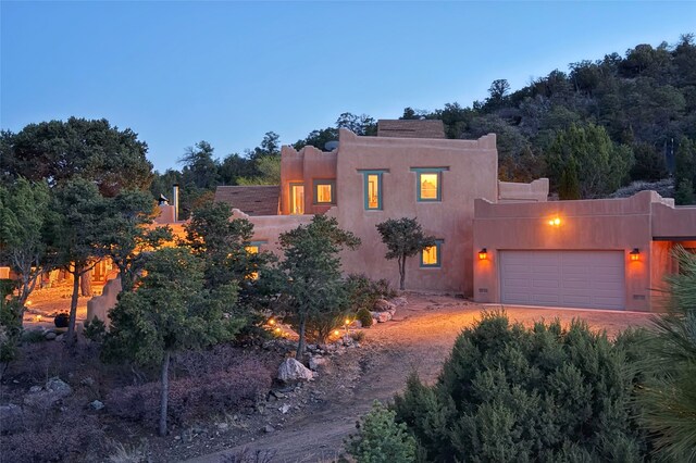 southwest-style home featuring a garage