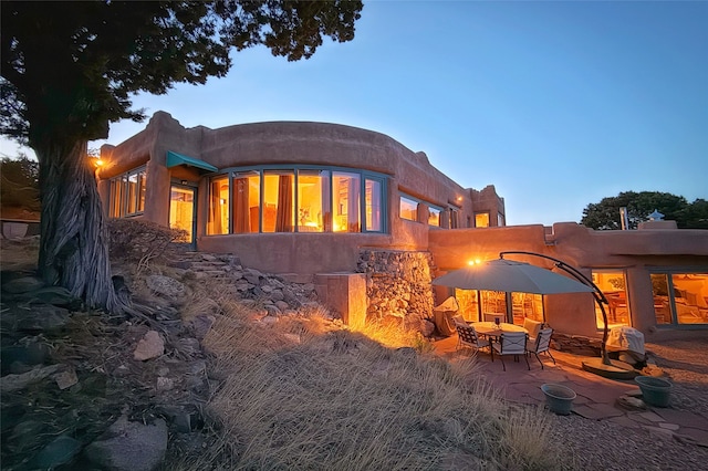 rear view of property featuring a patio area
