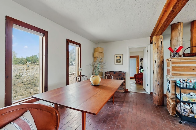 dining room featuring brick floor and a textured ceiling