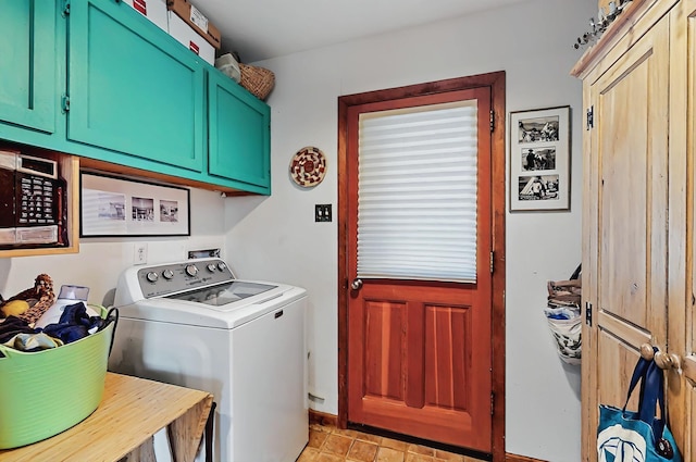 laundry area featuring baseboards, cabinet space, and washer / clothes dryer