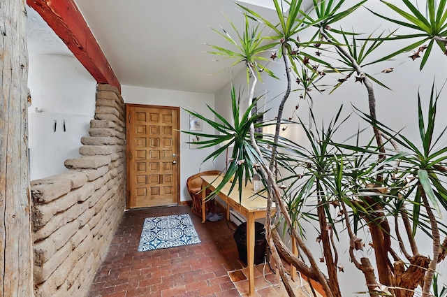 interior space featuring brick floor