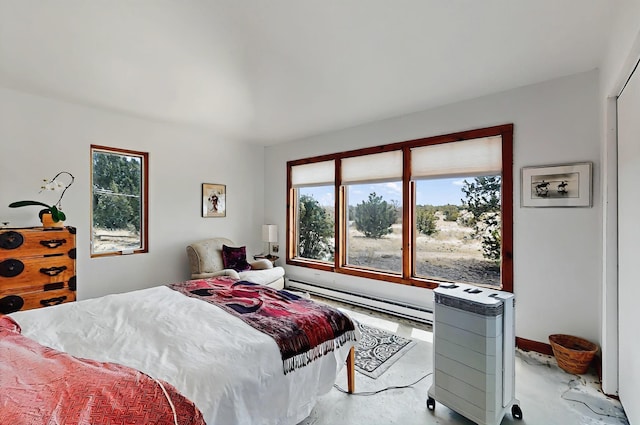 bedroom with finished concrete flooring and baseboard heating