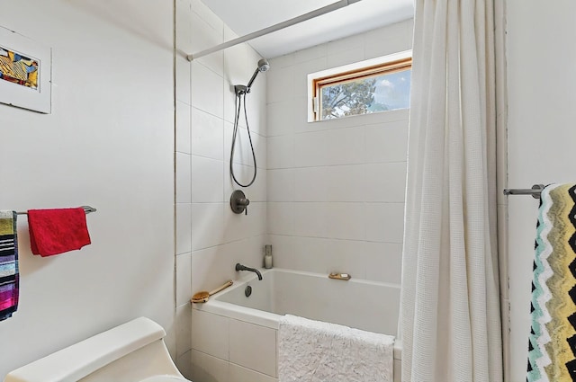bathroom with shower / bath combo with shower curtain and toilet
