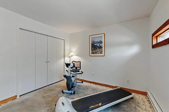 exercise area featuring baseboards and baseboard heating