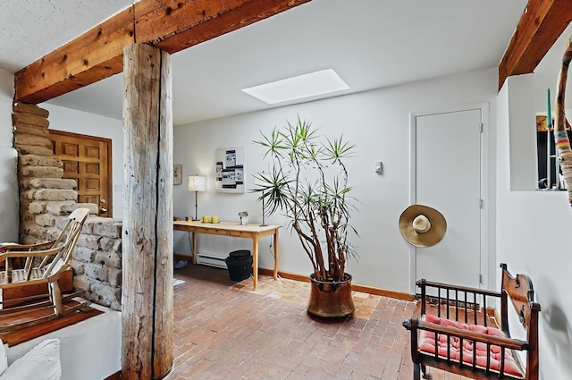 living area with a skylight and brick floor