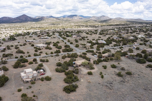 birds eye view of property featuring a mountain view, view of desert, and a rural view