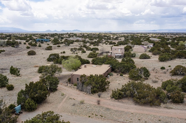 birds eye view of property featuring view of desert, a mountain view, and a rural view