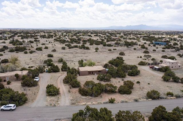 birds eye view of property featuring a rural view, a mountain view, and view of desert