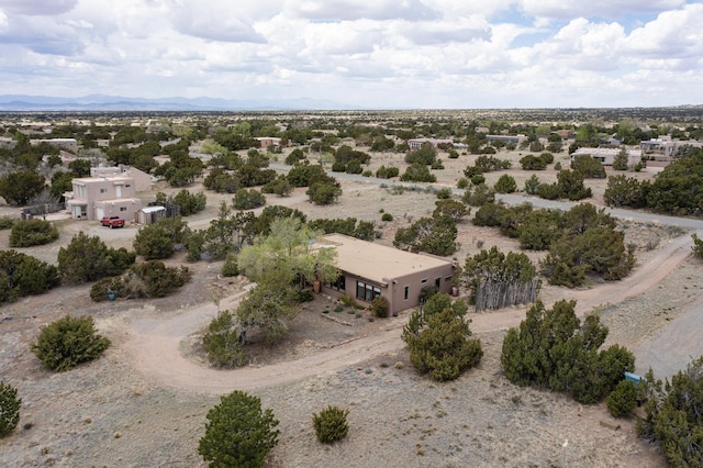 drone / aerial view with view of desert and a mountain view