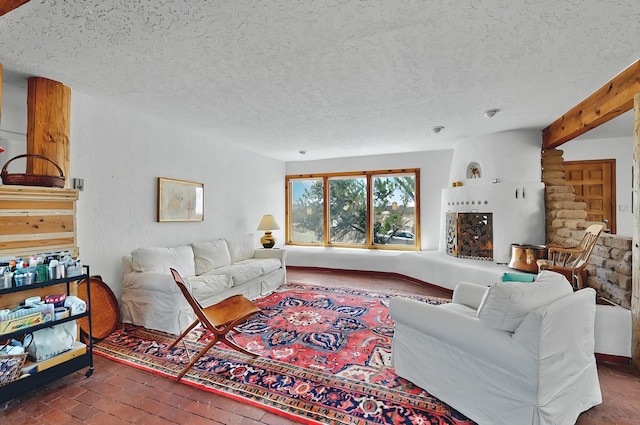 living area with a textured ceiling and brick floor