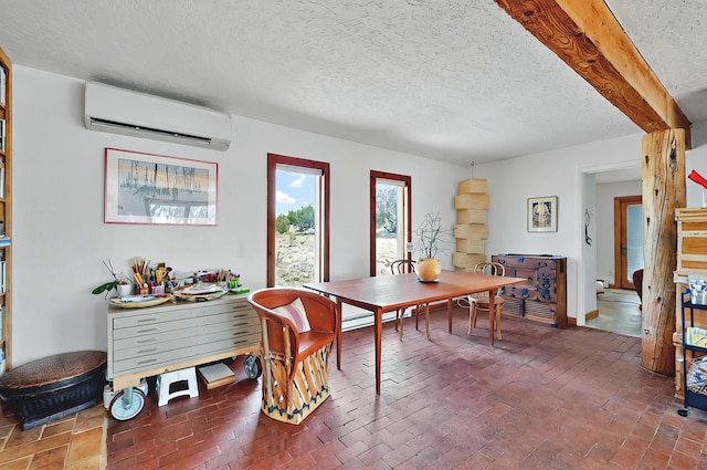 dining area with an AC wall unit, a textured ceiling, and brick floor