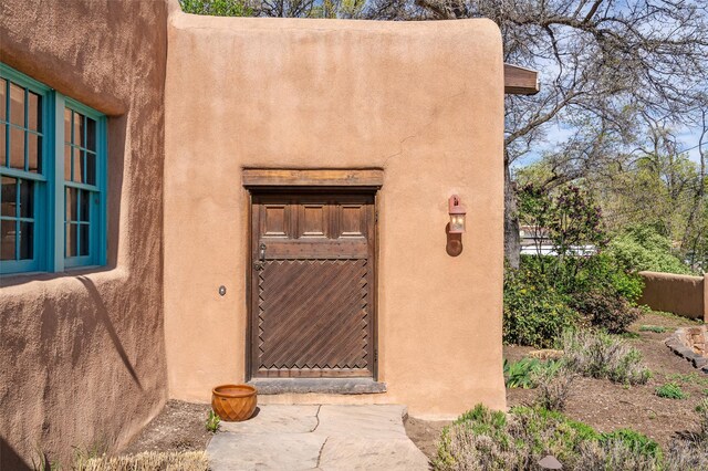 doorway to property with stucco siding