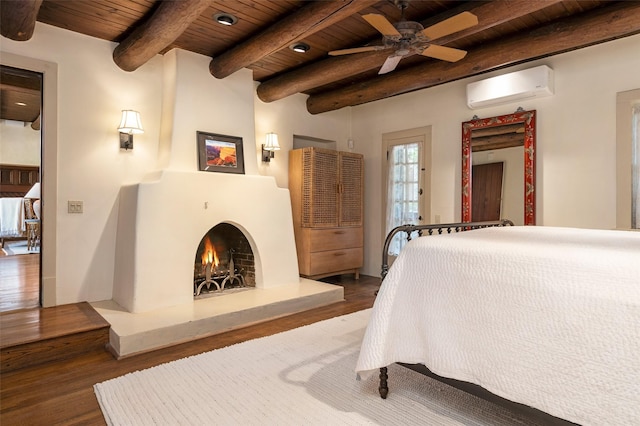 bedroom featuring wood finished floors, beam ceiling, a lit fireplace, an AC wall unit, and wood ceiling