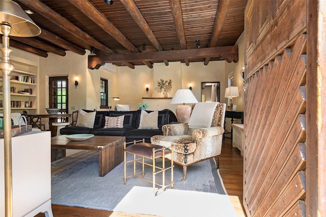 living room featuring beam ceiling, wood finished floors, and wooden ceiling