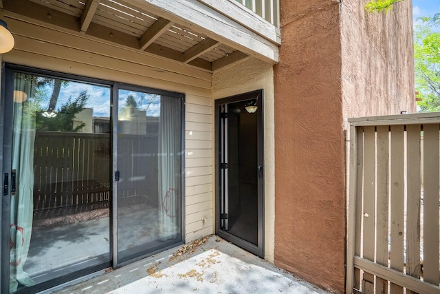 property entrance with stucco siding